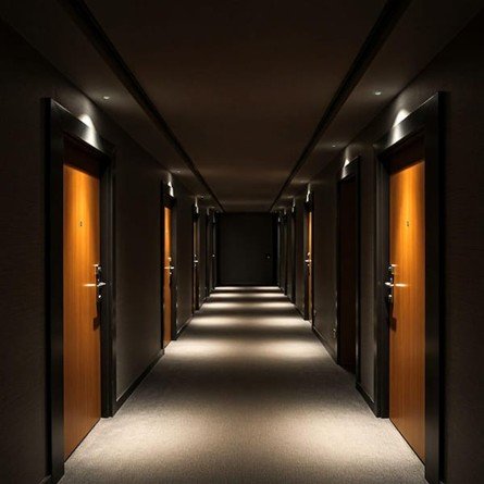 A dimly lit corridor receding