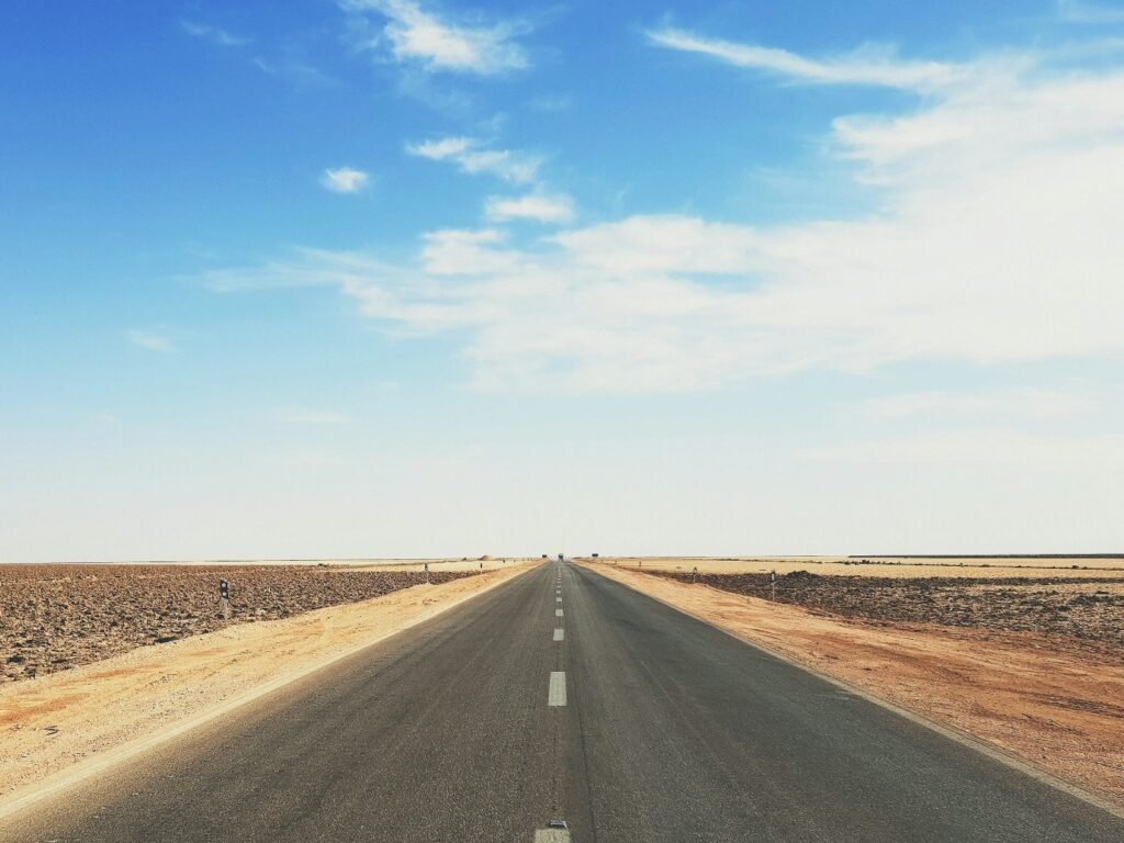 An empty road under a pale sky