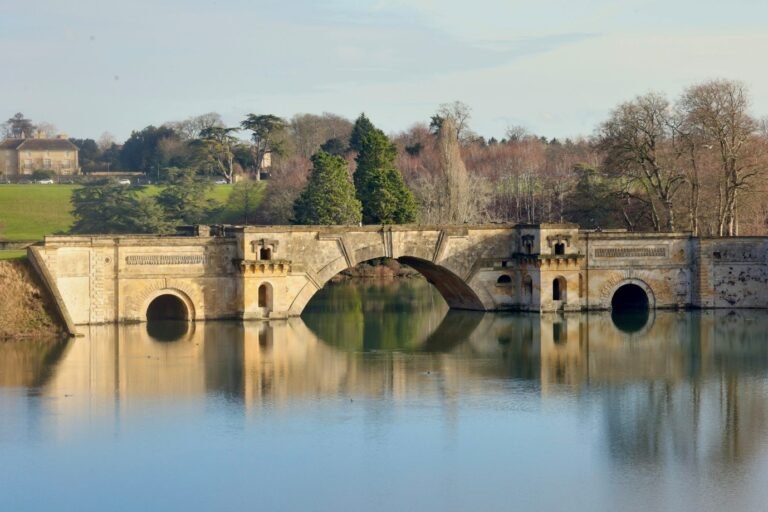 Old stone bridge crossing calm rural river