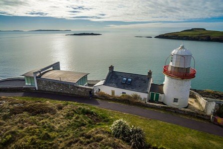 The road traces a deliberate line through solid terrain. Rock walls rise on either side while the route curves forward. Elevation and direction are clearly visible. The landscape feels open and expansive.