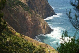 Narrow path running along the edge of a coastal cliff.