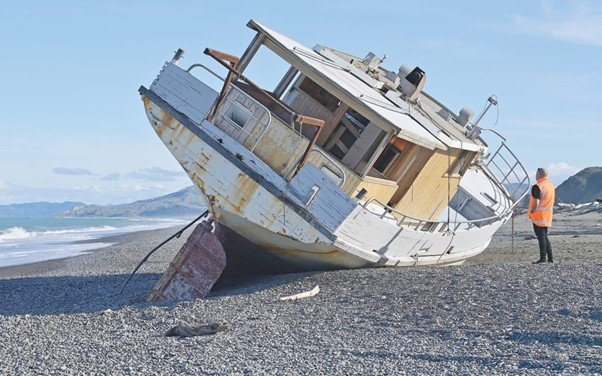 An old wooden boat resting on the shore