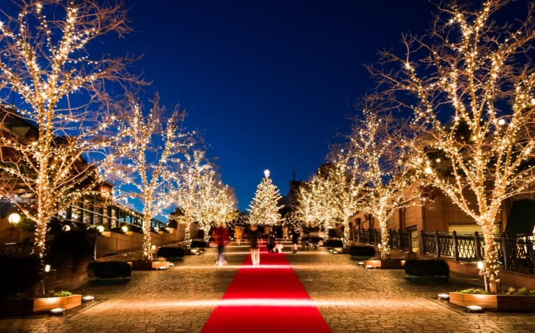 The tree is decorated with warm fairy lights and hanging white lanterns, creating a cozy, atmospheric