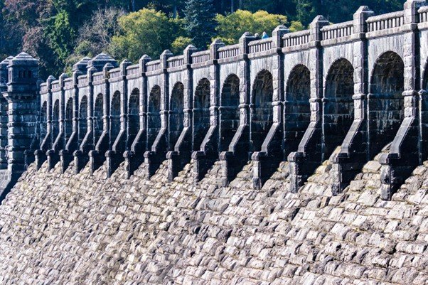 35 Sing a New Song Long stone reservoir wall receding into the distance.