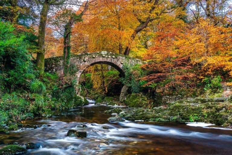 Long stone bridge crossing open countryside.