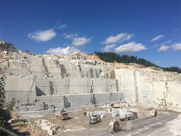 Stepped quarry terraces carved into exposed stone.