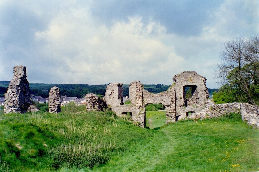 Weathered stone ruins standing on a hill overlooking open countryside.