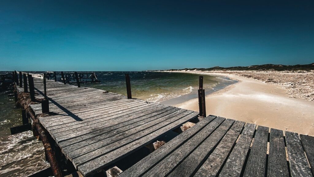 Weathered wooden pier extending out across the sea.