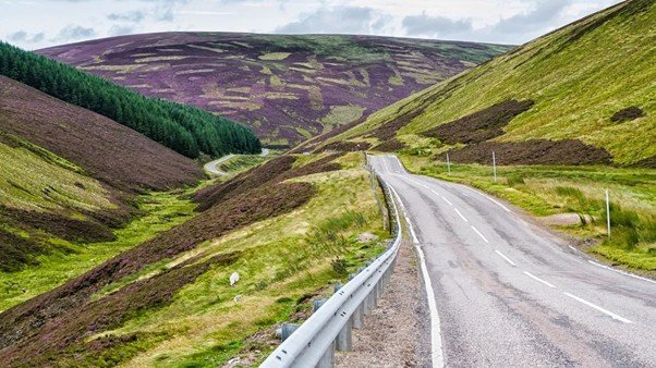 Narrow road winding through a mountain pass.