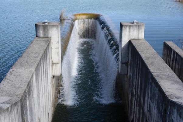 Water flowing down a large reservoir spillway.