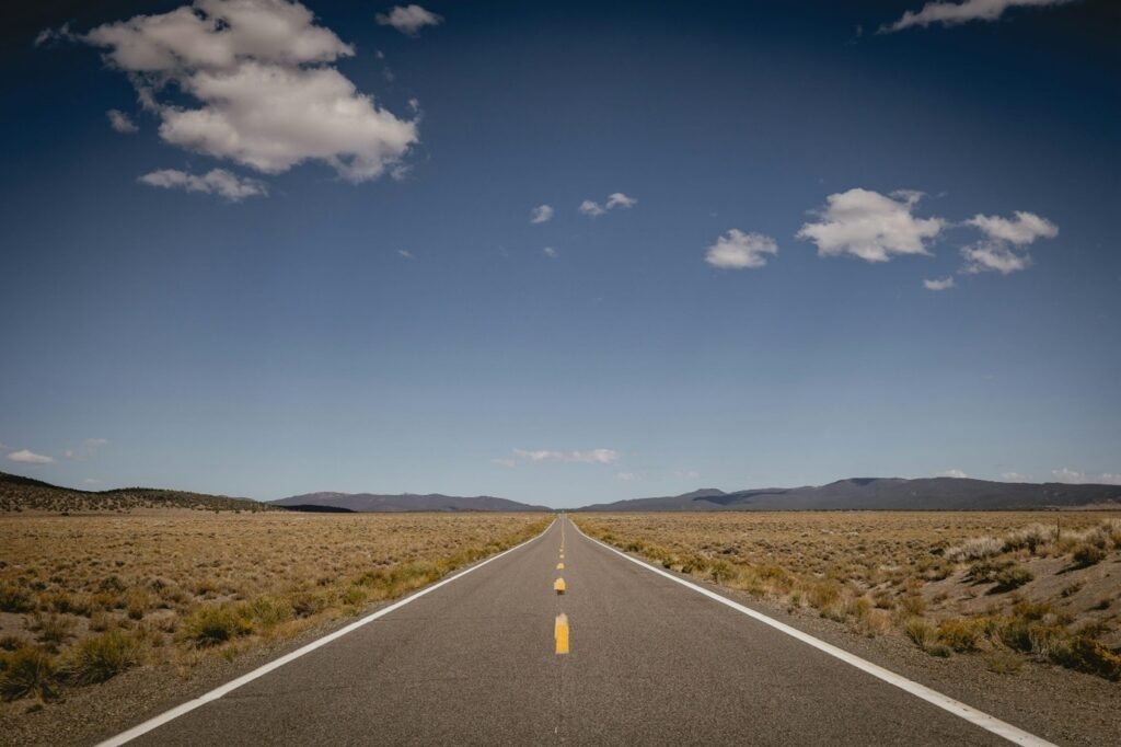 A long path continuing under an open sky