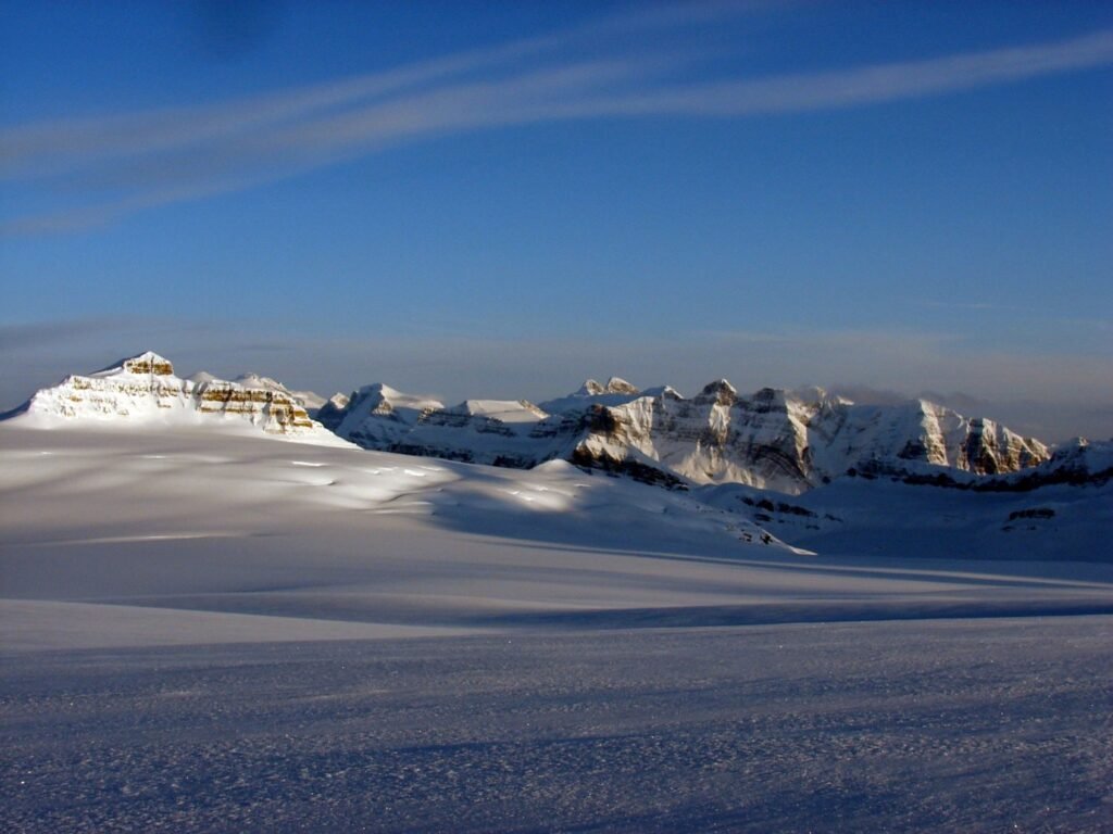 A wide glacier ice field stretching toward distant mountains.