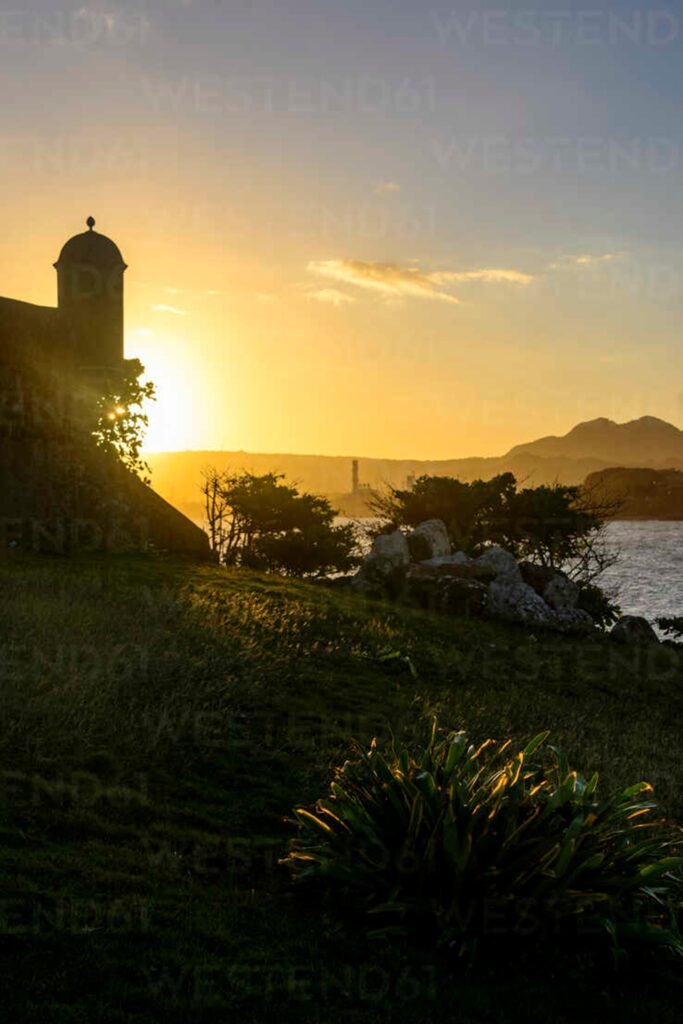 A watchtower silhouetted against a pre-dawn sky